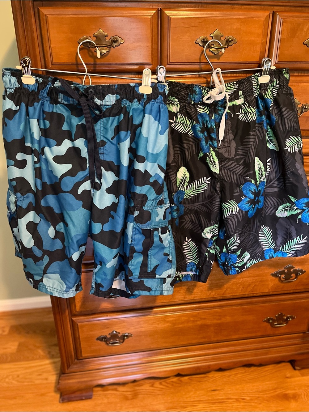 Pair of Kanu Surf Men's Blue Camo & Black Floral Swim Trunks